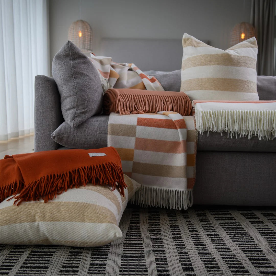 Bella Vita Sequence Cinnabar/Dark Beige throw draped over modern sofa