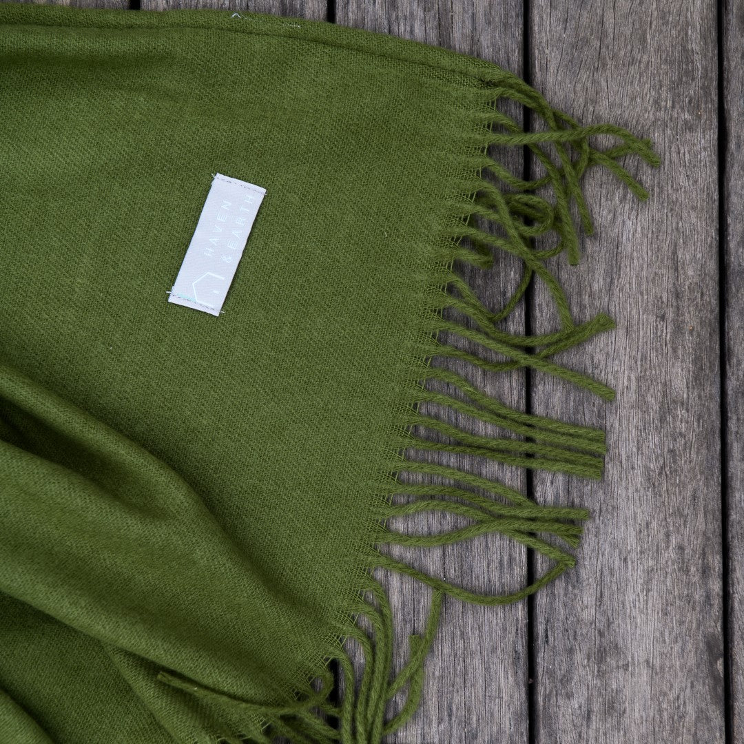 Close-up of hunter green Melody plain throw texture