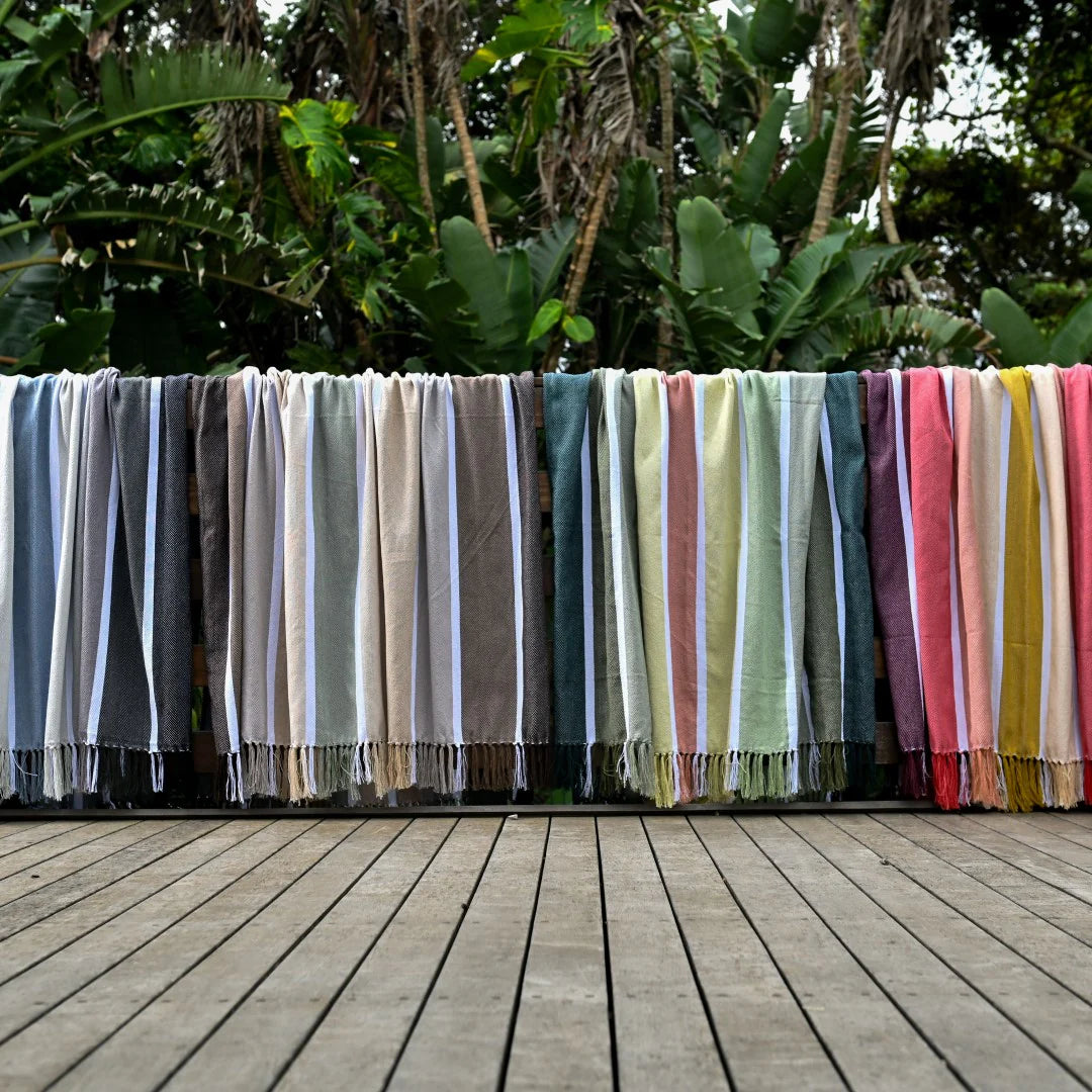Protea Pinstripe Sunset throw in bold striped design with hand-knotted fringes.