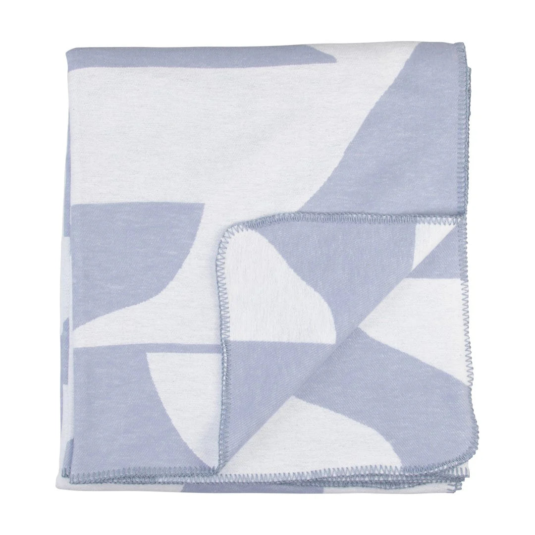 Folded blanket with geometric pattern on a white background