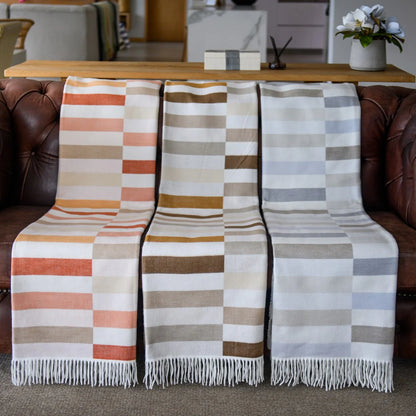 Haven & Earth Bella Vita Sequence throws draped over a sofa in a living room setting.