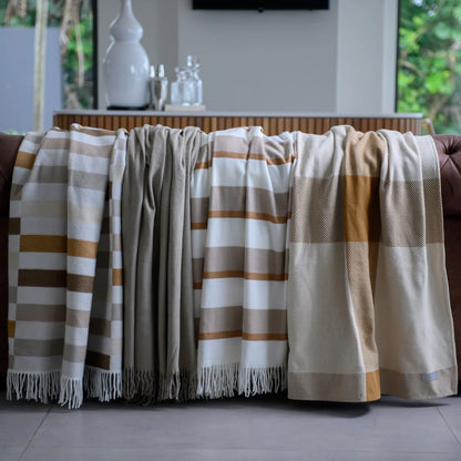 Bella Vita Sequence Cinnabar/Dark Beige throw draped over a sofa in a living room setting.