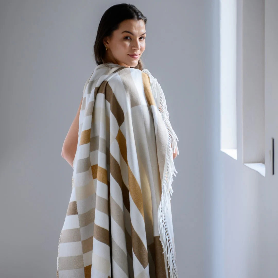 Woman draped in a Bella Vita Sequence Wild Dove/Oyster Grey throw against a neutral background