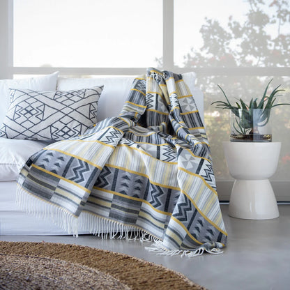Bring African luxury into your home with the My Africa Bella Vita Kente Throw in Wild Dove/Nugget Gold. Featuring traditional Kente patterns, this soft acrylic blanket celebrates African royalty and craftsmanship, adding elegance and colour to any room.