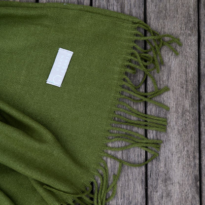 Close-up of hunter green Melody plain throw texture