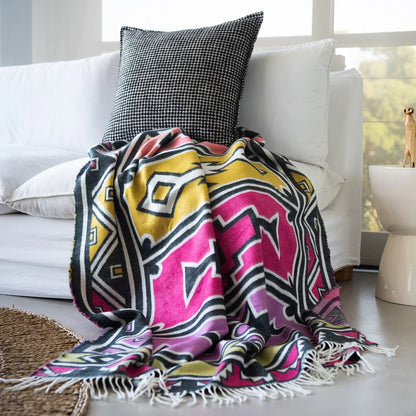 Bold and artistic, the Bella Vita Ndebele Throw in Cerise/Radiant Orchid celebrates vibrant Ndebele design. Featuring geometric motifs and bright colors, this soft acrylic blanket is a modern tribute to African identity and creativity.