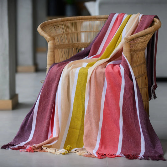 Protea Pinstripe Sunset throw in Burgundy/Garnet – rich striped design with hand-knotted fringes.