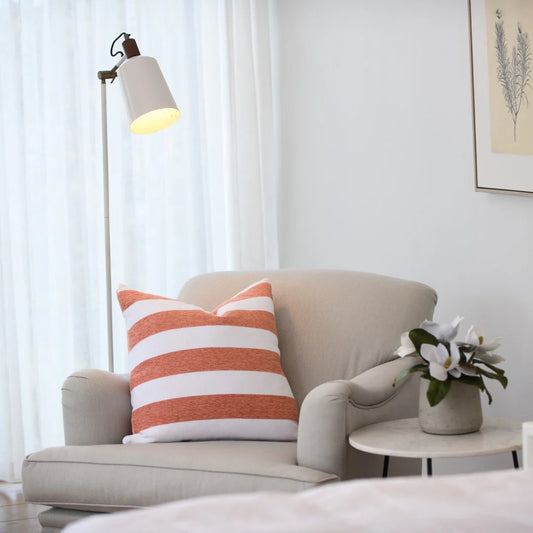 Protea Chenille Scatter Cushion in Canyon and White, 55x55 cm, soft chenille texture, styled on a contemporary armchair.