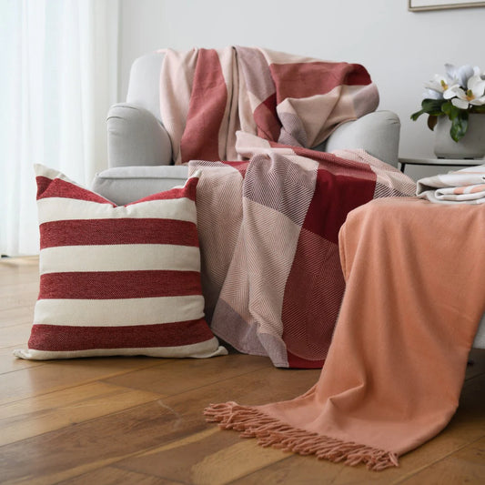 Protea Chenille Scatter Cushion in Garnet and Natural, 55x55 cm, textured chenille, displayed on a cozy sofa.