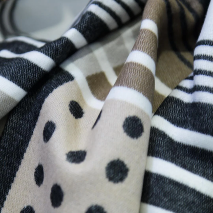 The Bella Vita Xhosa Umbhaco Throw in Black/Cobblestone reflects South Africa’s rich Xhosa traditions. Inspired by ceremonial wear, this elegant blanket is crafted from ultra-soft acrylic in a striking monochrome design.