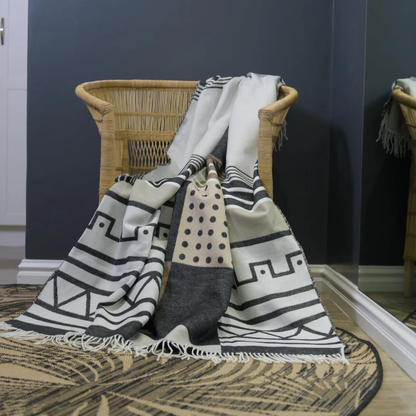 The Bella Vita Xhosa Umbhaco Throw in Black/Cobblestone reflects South Africa’s rich Xhosa traditions. Inspired by ceremonial wear, this elegant blanket is crafted from ultra-soft acrylic in a striking monochrome design.